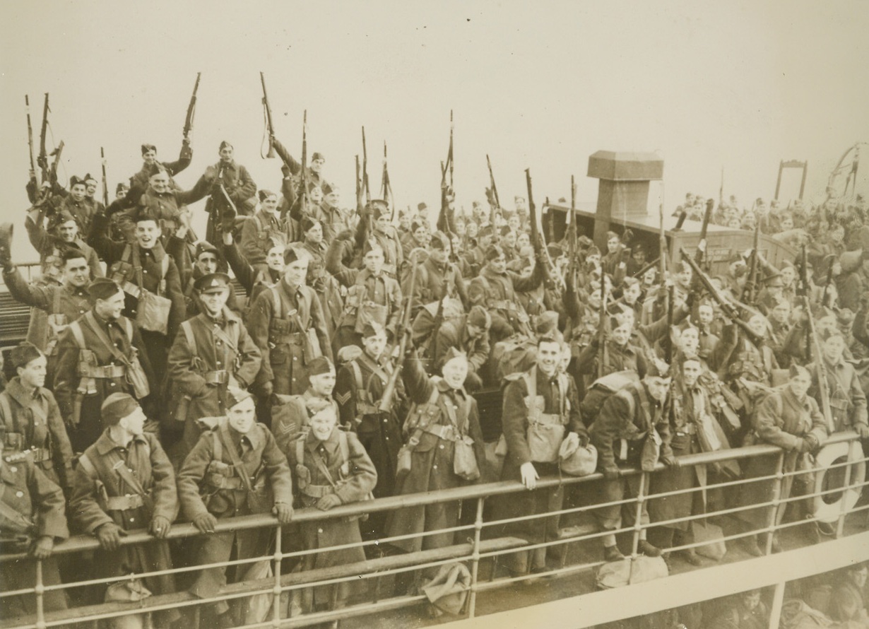 FIRST CANADIAN TROOPS ARRIVE IN ENGLAND, 1/3/1940  SOMEWHERE IN ENGLAND—Canadian troops, among the first Dominion Division to reach England for training to fit them for duty on the British front in France, raise a cheer alongside the quay as they arrived at an unidentified British port. Credit Line (ACME);