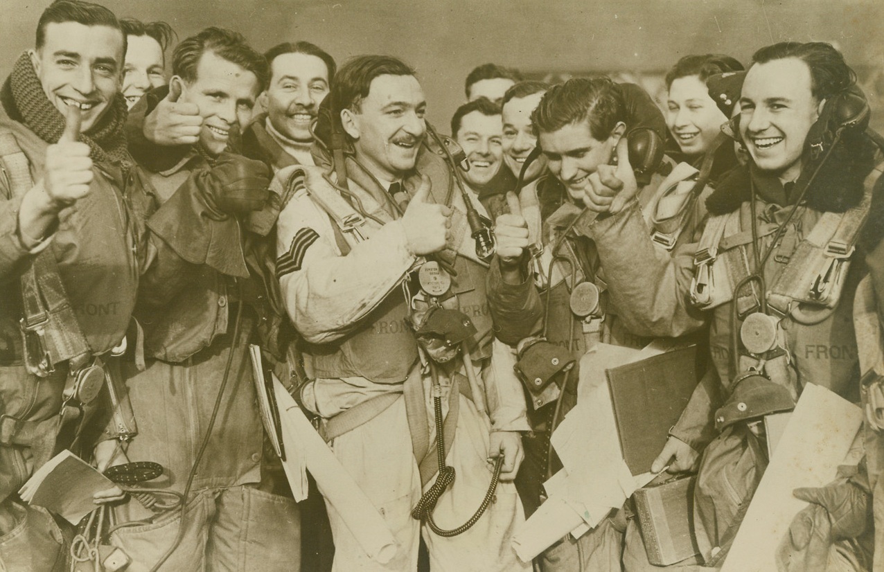 British Airmen In Heligoland Battle, 1/3/1940  Somewhere in England – Thumbs up for victory, some of the British Airmen who took part in the recent aerial combat over the Nazi Heligoland Naval Base, are shown upon their return to their home base “somewhere in England.” According to British reports, twelve Nazi Messerschmittt Bombers were shot down, while the British lost seven planes. Credit: ACME;