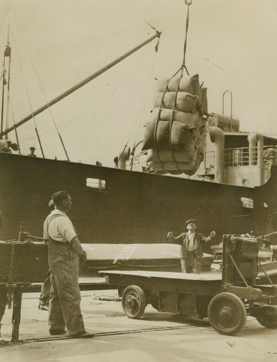 Business As Usual At Port of London, 8/31/1940  London - Denying German reports that the Port of London was put out of operation by smashing Nazi air raids, the British censor released this picture, showing flour from Australia arriving at the Port, and a caption reading “Port of London a Hive of Industry.” Credit: ACME;