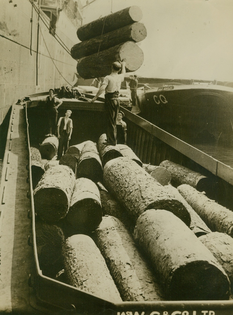 Business As Usual At Port of London, 8/31/1940  London - Denying German reports that the Port of London was put out of operation by smashing Nazi air raids, the British censor released this picture, showing timber from Canada arriving at the Port, and a caption reading “Port of London a Hive of Industry.” Credit: ACME;