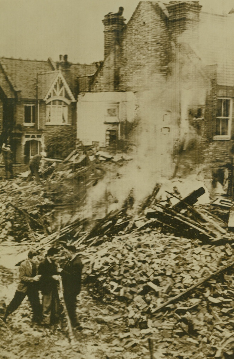 WHERE NAZI PLANE FELL ON LONDON HOUSE, 9/20/1940  LONDON—Blazing wreckage of a raiding German plane after it fell and smashed a London home. Credit: Acme Cablephoto;