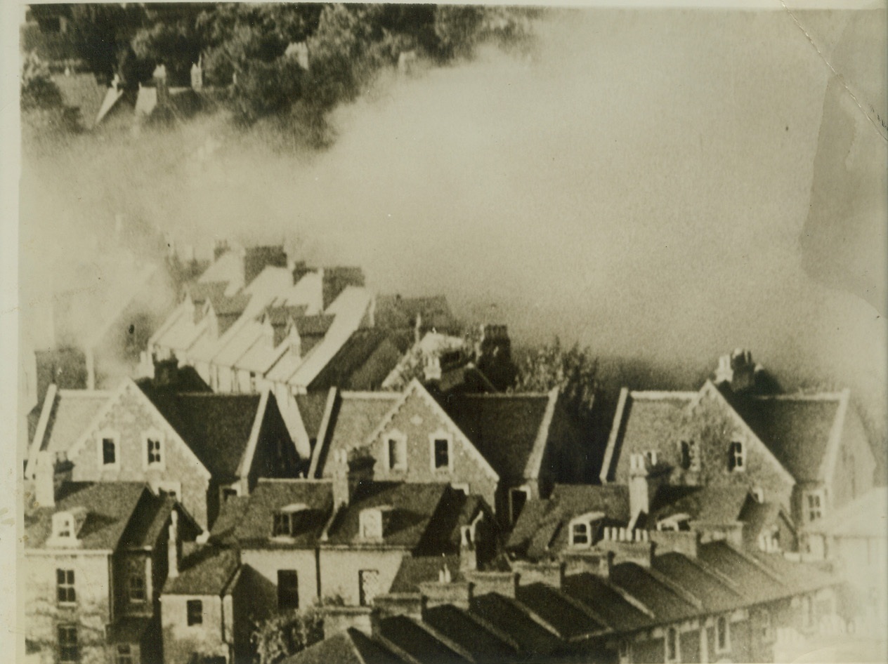 Fires Rage in Bombed Dover, 9/23/1940  DOVER, ENGLAND -- Smoke drifts over the roofs of these Dover houses after one of the Nazi air raids whose frequency and fierceness on this southeast coast port have caused it to be renamed "Hell's Corner". Credit: (Movietone News from ACME);
