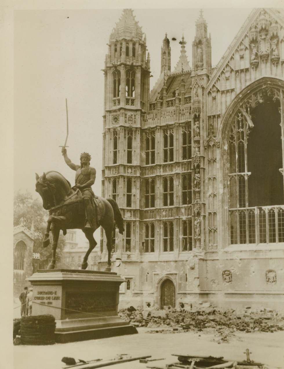 Richard Still Rides, 10/18/1940  LONDON -- When a bomb burst near the Houses of Parliament during a recent German air raid, the bronze statue of Richard I (Richard Coeur De Lion) escaped with but a bent sword. Note damage done to the building in background. Credit: (ACME);