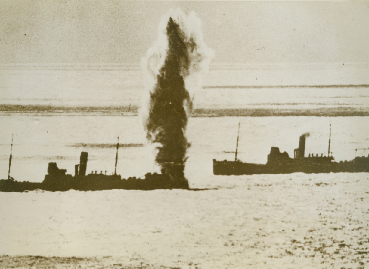 Nazi Channel Guns Bombard British Convoy, 11/25/1940  ENGLISH CHANNEL – Steaming under the noses of German coastal guns, one ship of an English convoy barely escapes destructing when a shell misses it by only a few feet. Germans claim to have destroyed part of this convoy, driving the remainder back to port. Credit: (ACME);