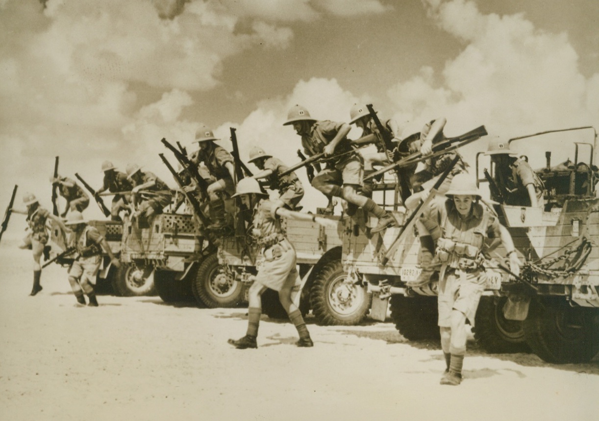 French Syrian Troops Aid British in Desert, 12/26/1940  NORTH AFRICA – Members of the French Colonial Army in Syria, who have joined British Forces in the Desert Campaign, are shown leaving their trucks at a point in the desert. Passed by Censors.;