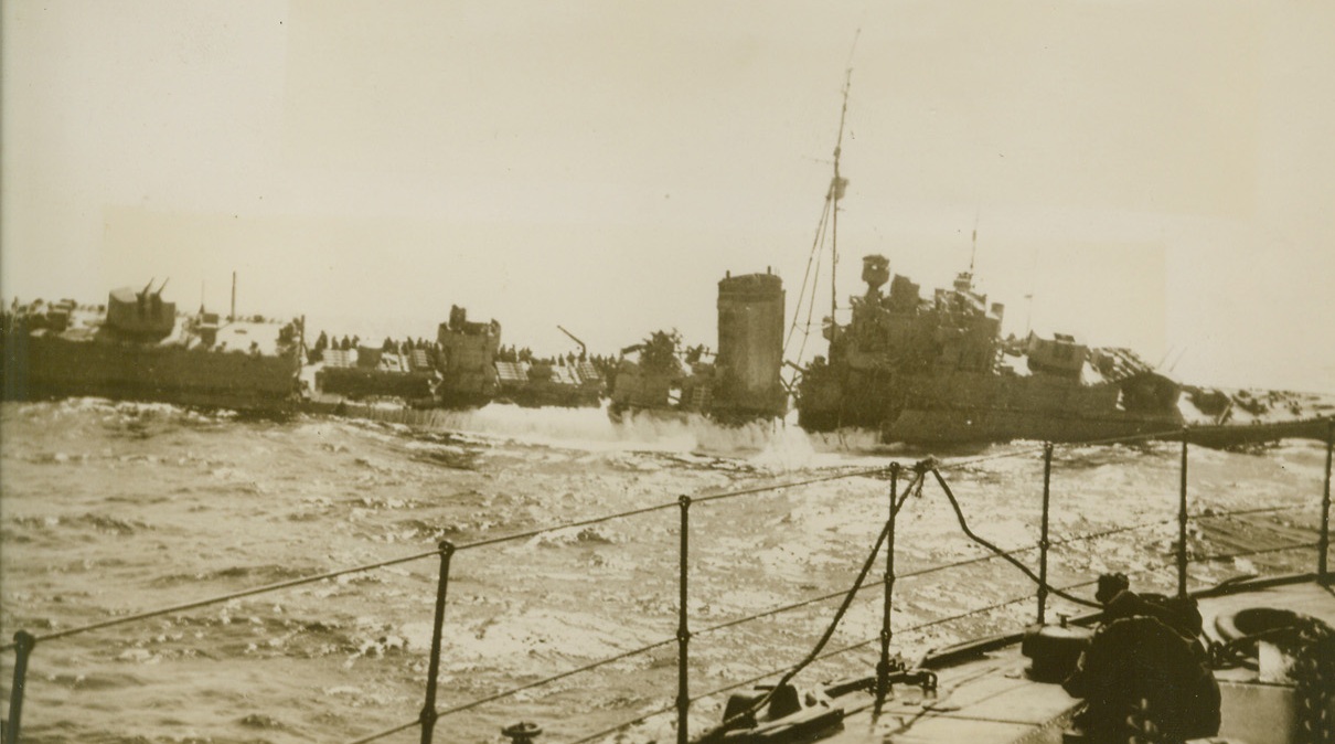 Torpedoed British Destroyer Makes Port, 12/26/1940  England – Her decks awash and listing heavily, the British destroyer flotilla leader H.M.S. Kelly is shown in this remarkable picture after she had been struck by a torpedo from a German motor torpedo boat. Members of her crew can be seen on the listing decks. The Kelly was towed into a British port and refitted, disproving the German claims made in a communiqué last May that she had been sent to the bottom. The torpedoing took place in the North Sea off the coast of Germany. Passed by British censor. Credit: ACME;