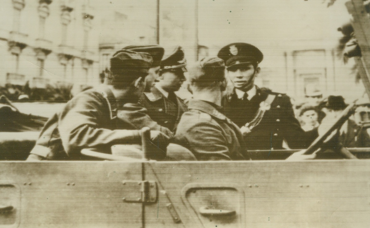 German Fliers Arrive in Italy, 1/11/41  ITALY – “Italians greeting German fliers upon arrival in Italian city,” was the meager caption accompanying this picture, radioed from Berlin. According to a Rome announcement, German fliers recently took part in an Italian torpedo-plane and dive bombing attack on a formation of British warships in the Sicilian Channel. Credit: (ACME Radiophoto);