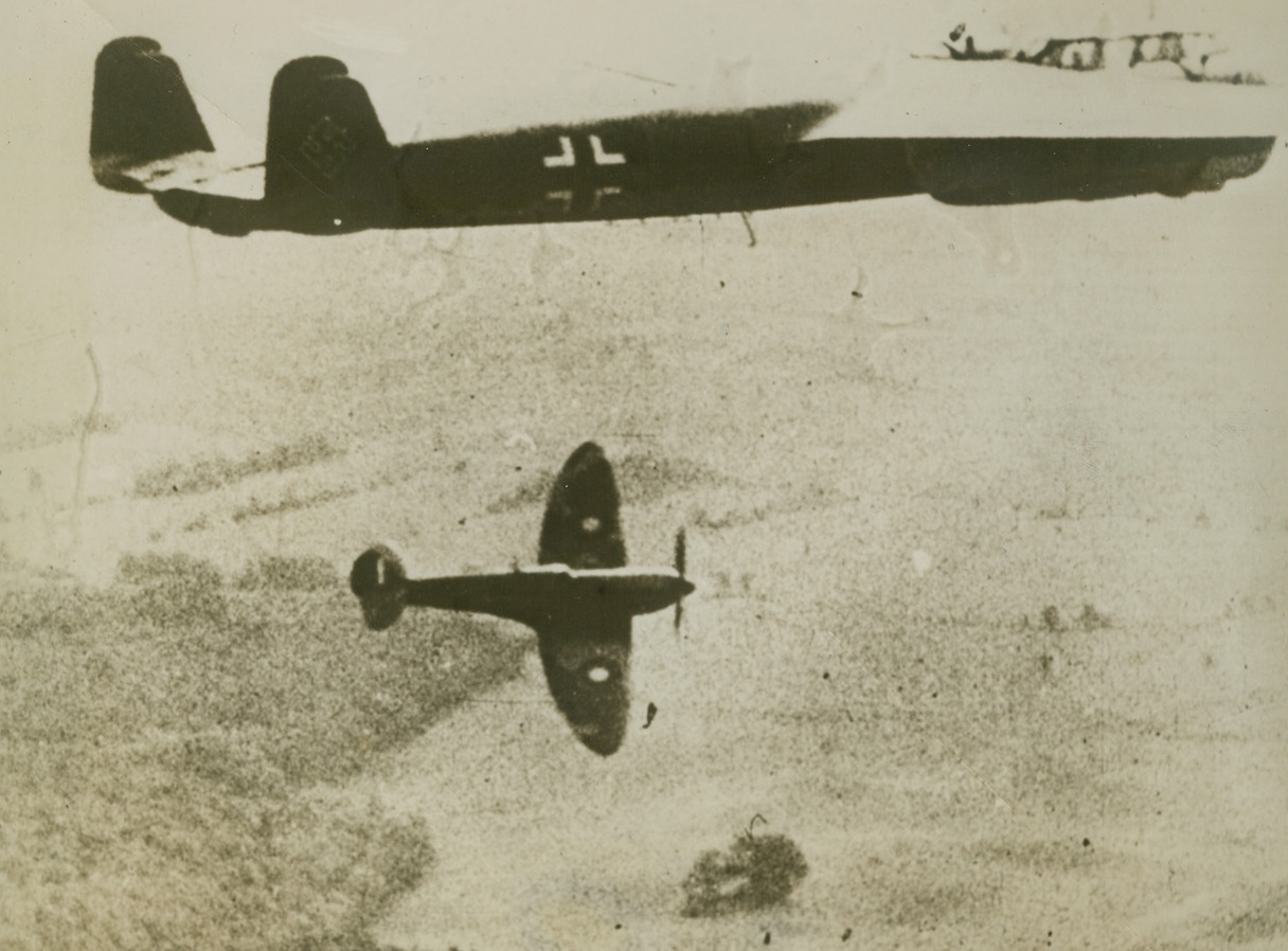 Air Adversaries Establish “Contact”, 1/18/41  “Over England”—According to the German caption this picture shows a British spitfire, retiring earthward after an unsuccessful attempt to bring down the DO-17 German plane flying over England.  Credit: ACME.;