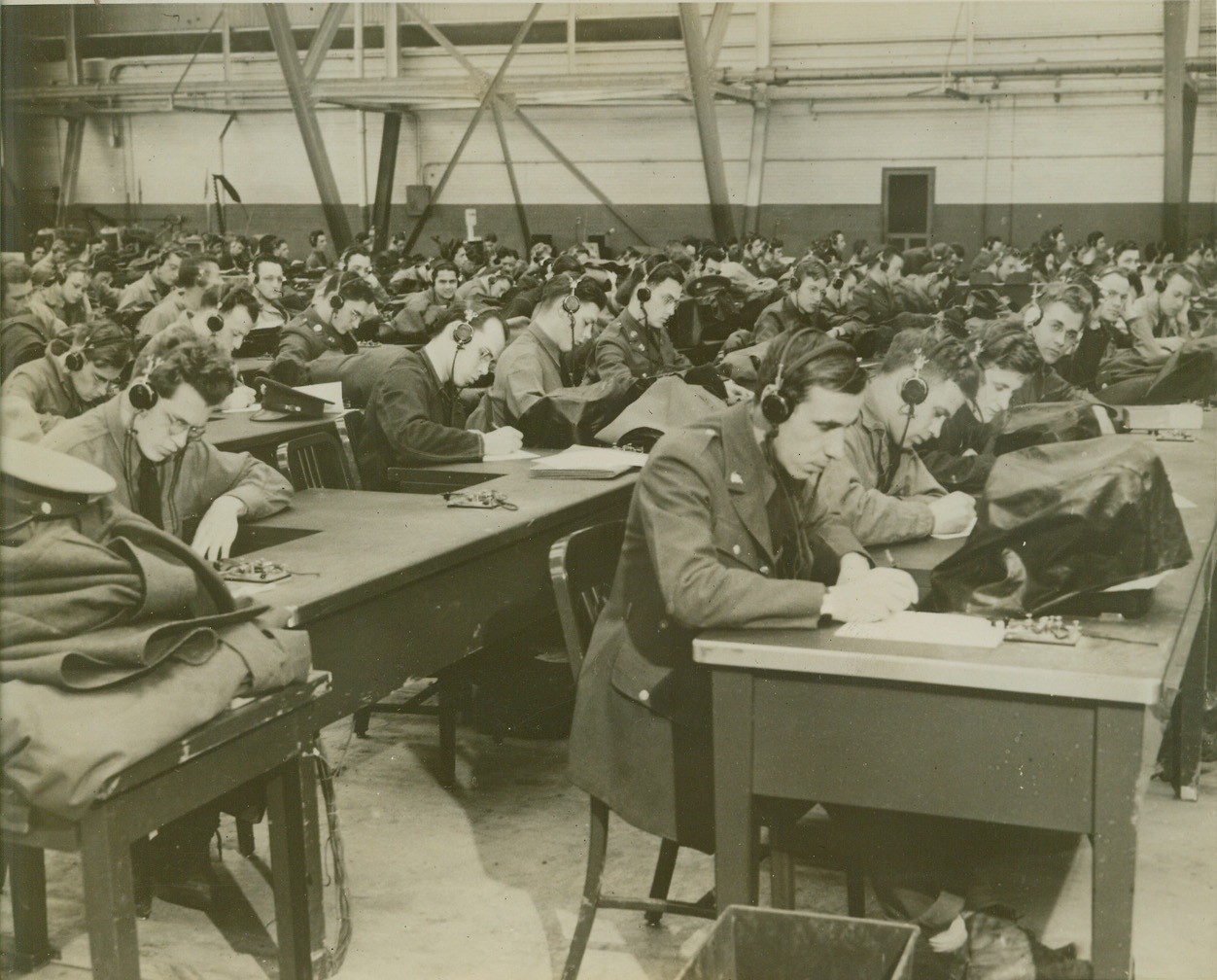 “Hams” of Other Years in the Army Now, 1/25/41  Belleville, Ill.—A lot of those “hams” you used to hear on short waves are in the Army now. Here’s a view of some 500 of them at Scott Field, the Army’s largest school for Air Corps radio operators and teletype men, receiving instruction in code transmission and receiving. Credit: ACME.;