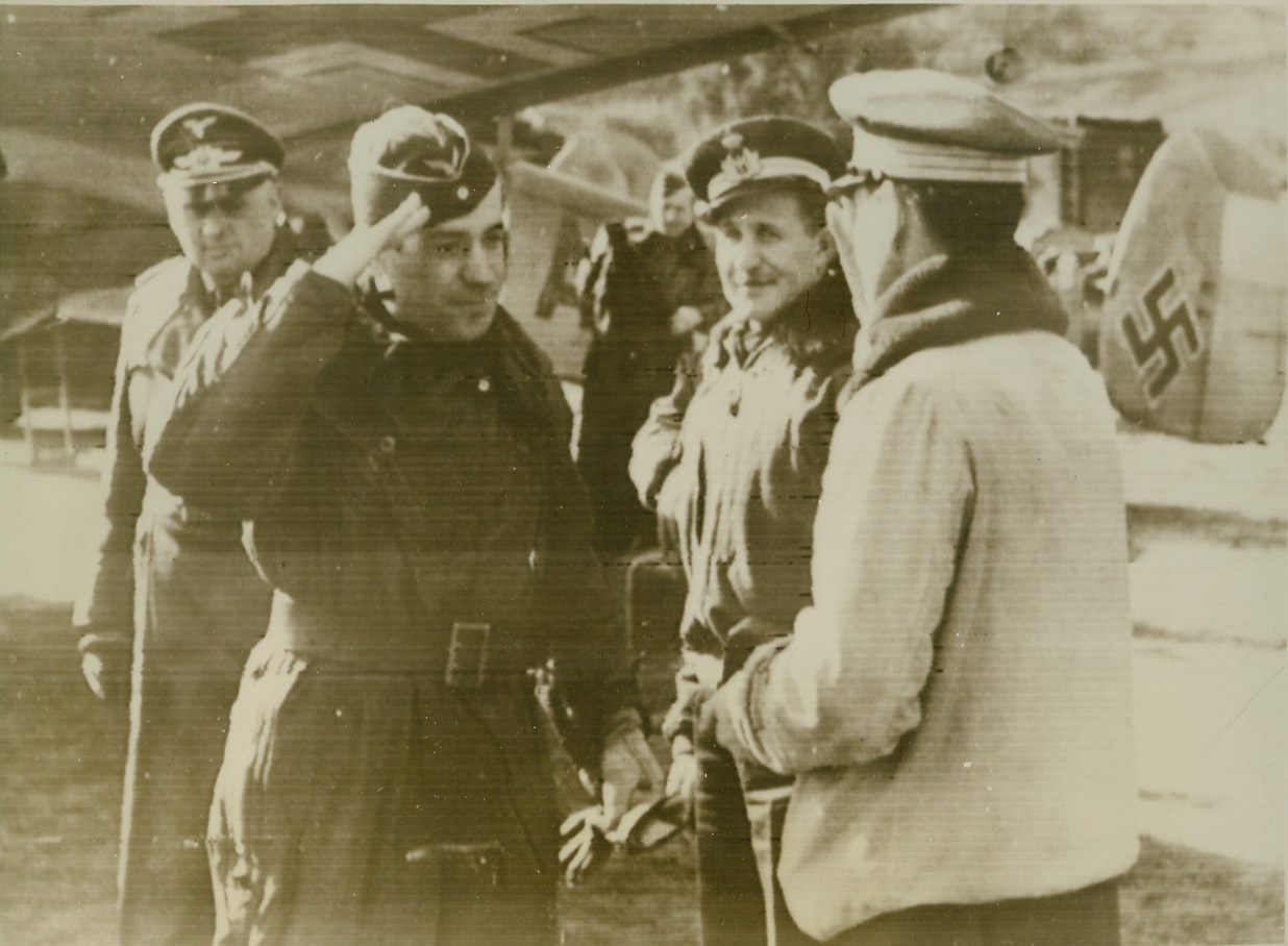 German Aces in Italy, 1/29/41  Italy – The German censor, in stating that German airmen (left) are shown reporting to an Italian air base commander, did not mention the locality. However, he did say that these air aces, and many others of the Luftwaffe, would be used to attack British bases in the Mediterranean. Photo radioed from Berlin to New York, January 29. Credit (ACME Radiophoto);