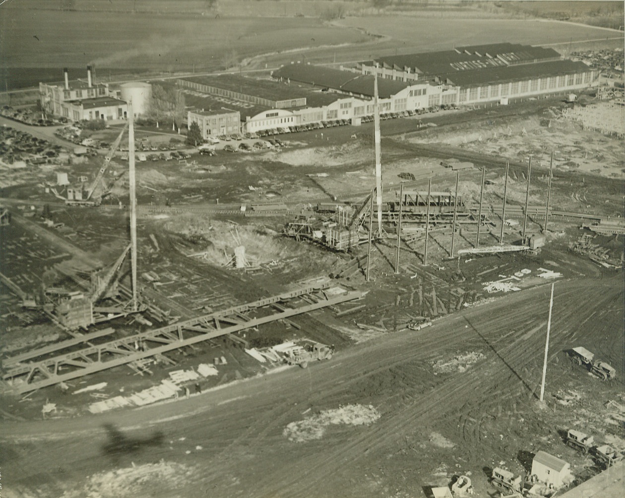 Curtiss-Wright Expand St. Louis Plant, 2/1/41  ST. LOUIS, MO. – Aerial view of construction work on the new Curtiss-Wright plant near Lambert-St. Louis airport. In the background is the present plant, not nearly large enough now to put out the material expected from it on the national defense program. Your credit: must read “ACME”;