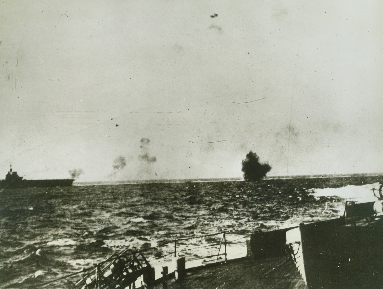 BOMBING OF HMS ILLUSTRIOUS IN MEDITERRANEAN, #1, 10/27/41  MEDITERRANEAN—This is the start of German dive-bombing attack on the British aircraft carrier Illustrious, which was the main target of six air attacks in the Mediterranean, suffering several hits. This exclusive picture is the first of a sequence of three, received today by clipper, passed by British censor. The vessel is now undergoing repairs in an American port. Credit: Acme;