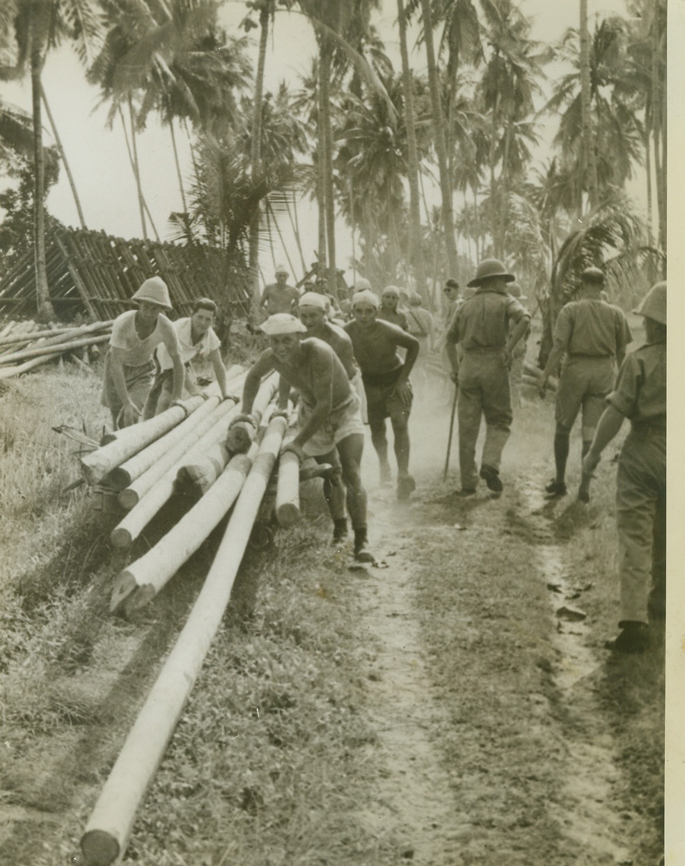 They’re Fighting for Britain, 12/11/41  Malaya – Men of a battalion of the Gordon Highlanders carry out construction work in the tropical jungle.  Yesterday British and Malayan troops fought Japanese on the beaches of Malaya, some 200 miles North of Singapore. Credit line (ACME);
