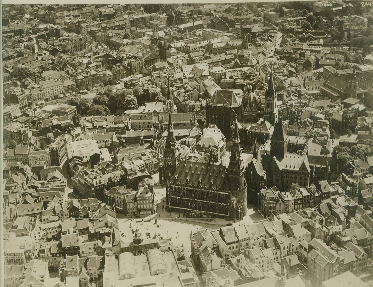 REPORTED BOMBED BY ALLIED PLANES, 9/6/1939. PARIS:- An unconfirmed report, Sept. 6, asserted that Allied planes had heavily bombed the German Rhineland industrial centers, principally around Aix La Chapelle (Aachen). Above is a general view of Aix La Chapelle. In center foreground is the City Hall (Rathaus), which in part dates back to the days of the Karolingian Emperors of the Holy Roman Empire of the Middle Ages. Credit: ACME;