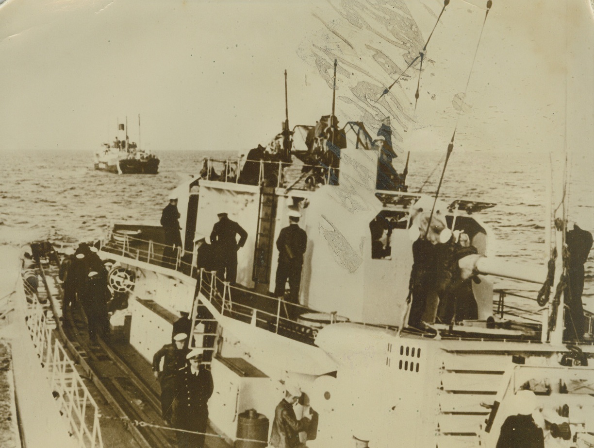 German Contraband Control in Action, 12/22/1939. A ship of the German contraband control, which operates mostly in the North Sea, leads a vessel stopped for search to a nearby port. Germany’s efforts to halt supplies to the Allies have met with marked success, according to Nazi figures. Credit: ACME.;