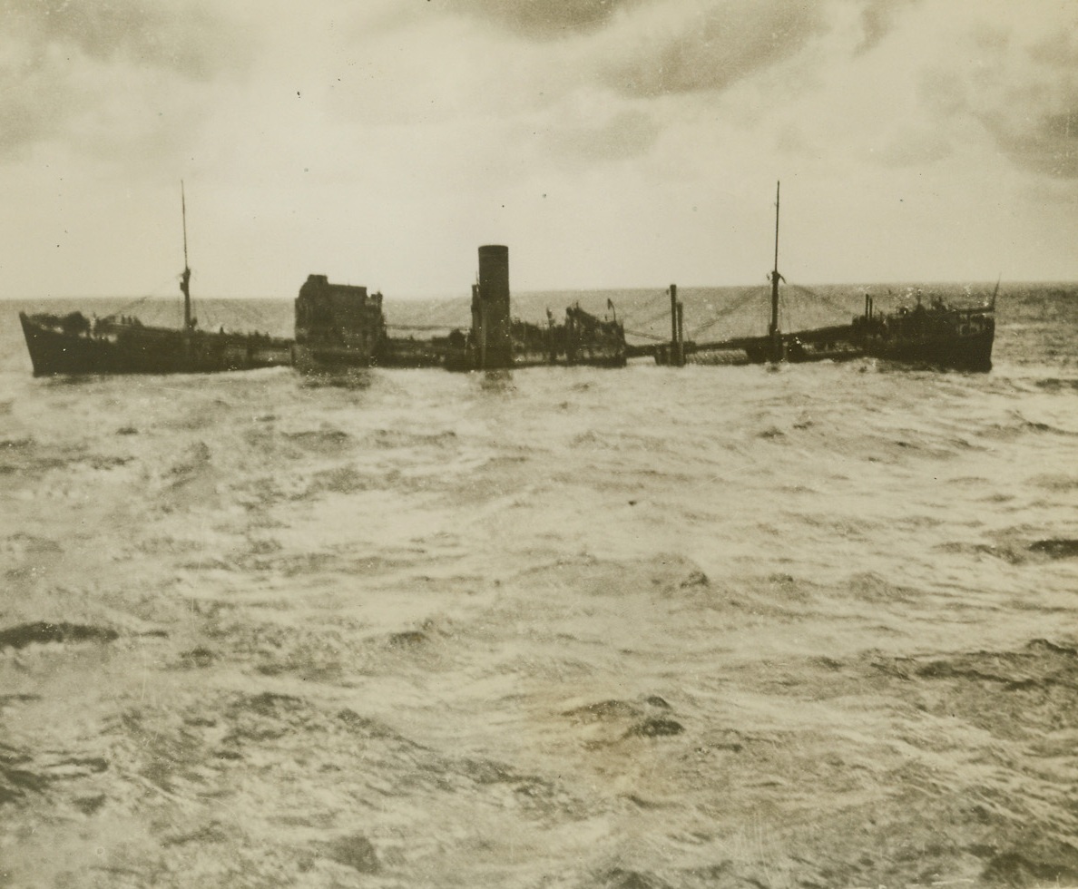 ANOTHER U-BOAT VICTIM, 12/27/1939. The British steamer S.S. Malabar sinking in the Atlantic, after being torpedoed by a submarine.  The ship broke in two during her final plunge.  The third engineer and four Lascar firemen were killed by the explosion, but 76 officers and crew were picked up by a British warship.Credit: Acme;