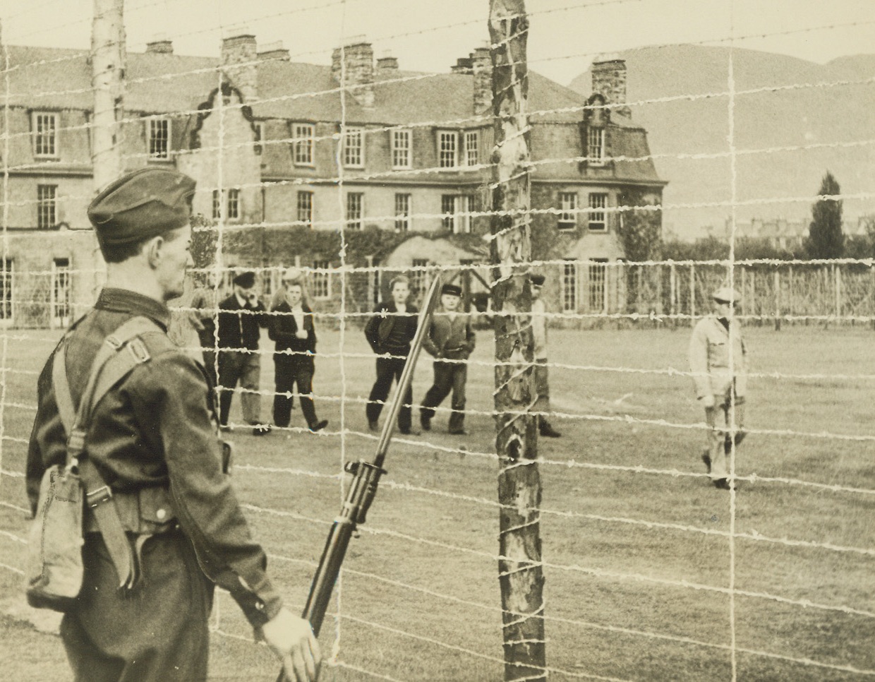 German Prisoners of War in a British Internment Camp, 11/9/1939. Somewhere in England – This picture is one of the first to be made of German prisoners of war, captured and interned for the duration at a large country mansion. The prisoners, among them U-Boat crews, are pictured exercising on the fenced and well-guarded grounds of the mansion. Freedom for exercise, good food and liberty to listen to British Broadcasting Company News and programs is given them to make their confinement as easy as possible. Passed by Censor Credit: ACME;